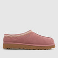 Pink UGG slipper with brown sole on a light gray background